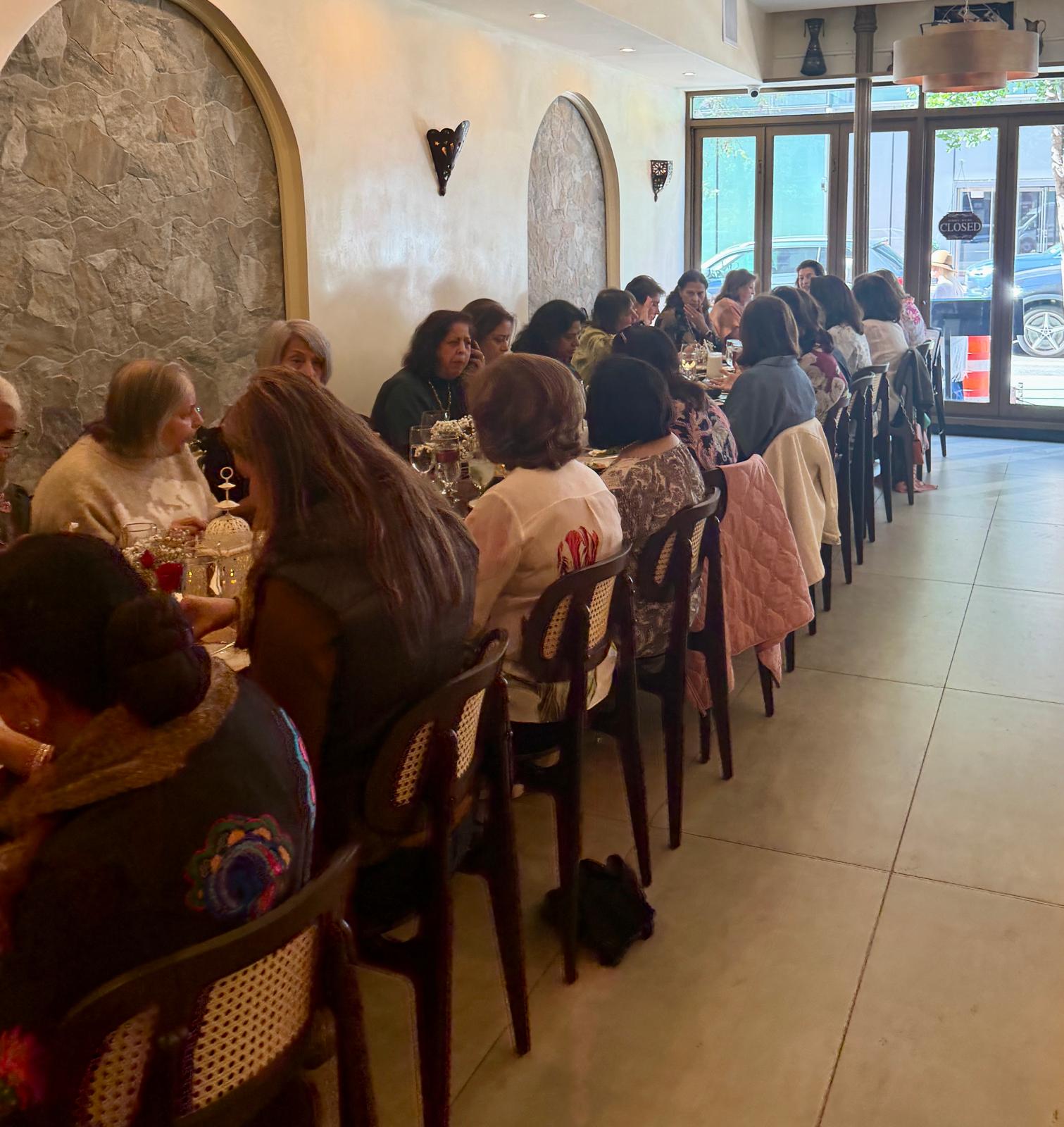 Dining room — long table along the stone-niche wall